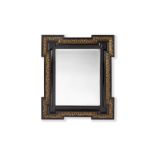 A 19TH CENTURY FRENCH EBONY VENEERED AND PARCEL GILT DECORATED MIRROR