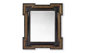 A 19TH CENTURY FRENCH EBONY VENEERED AND PARCEL GILT DECORATED MIRROR