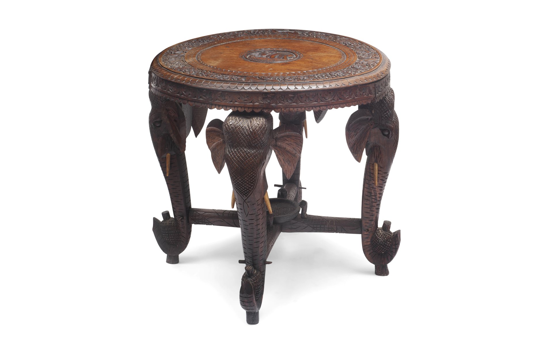 AN EARLY 20TH CENTURY INDIAN CARVED WOOD TABLE OF ELEPHANT THEME