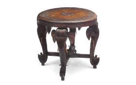 AN EARLY 20TH CENTURY INDIAN CARVED WOOD TABLE OF ELEPHANT THEME