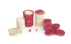 A SET OF CHINESE 19TH CENTURY IVORY GAMING SHAKERS AND COUNTERS