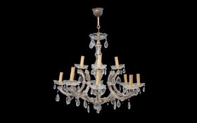 AN 18TH CENTURY STYLE CUT AND MOULDED GLASS TWELVE LIGHT CHANDELIER