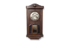 A 1930'S OAK WALL CLOCK