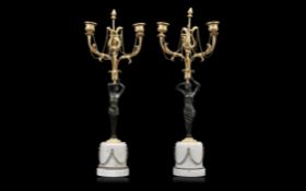 A PAIR OF 19TH CENTURY GILT AND PATINATED BRONZE FIGURAL CANDELABRA