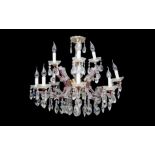 AN 18TH CENTURY STYLE TWELVE LIGHT CUT AND MOULDED GLASS CHANDELIER