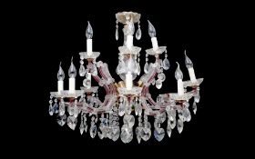 AN 18TH CENTURY STYLE TWELVE LIGHT CUT AND MOULDED GLASS CHANDELIER