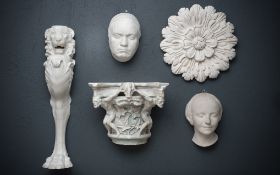 A COLLECTION OF FIVE WALL MOUNTED PLASTER RELIEFS