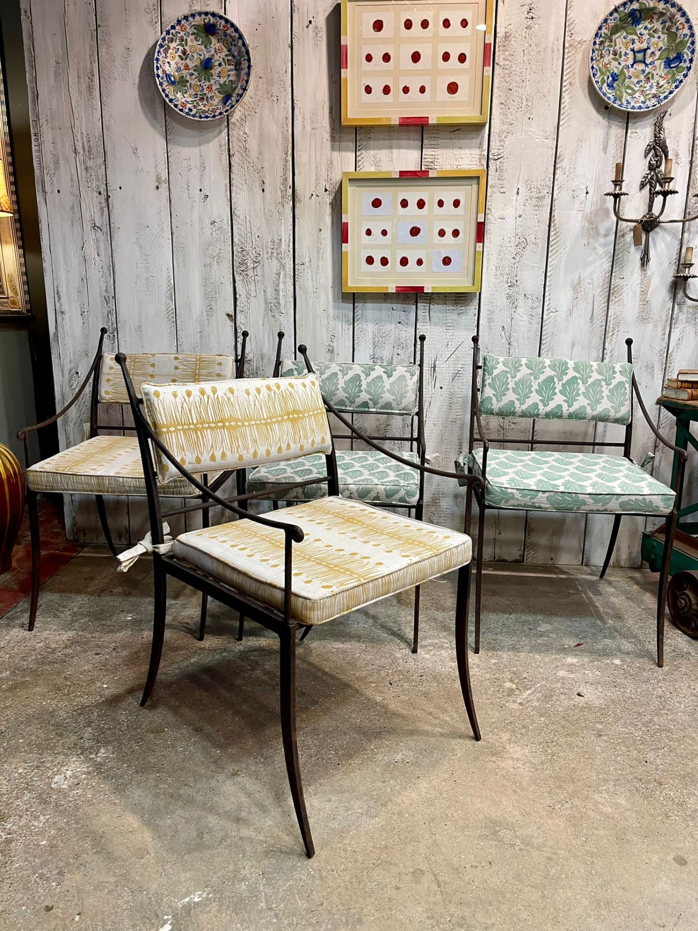 A SET OF FOUR IRON GARDEN CHAIRS WITH CUSHIONS