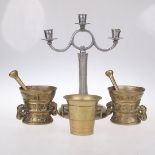 THREE BRONZE PESTLES AND MORTARS AND A CANDELABRA