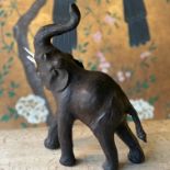 A LIBERTIES STYLE LEATHER COVERED MODEL OF AN ELEPHANT