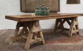 A LARGE DINING TABLE ON TRESTLE BASE