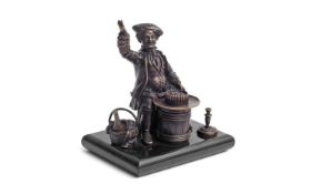 A REGENCY BRONZE PEN HOLDER IN THE FORM OF A JOVIAL GENTLEMAN