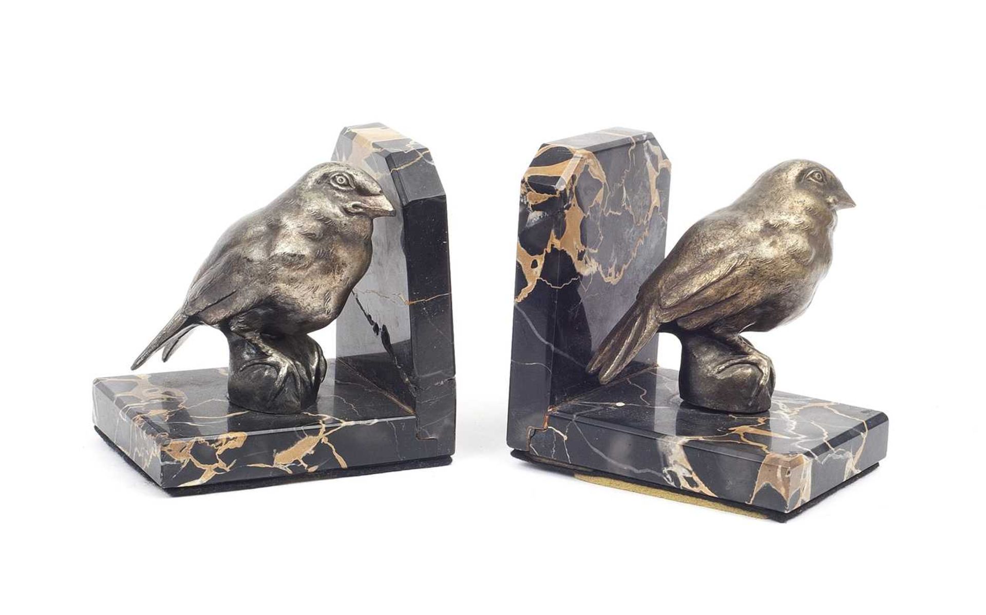 A PAIR OF ART DECO STYLE SILVERED AND MARBLE BIRD BOOK ENDS