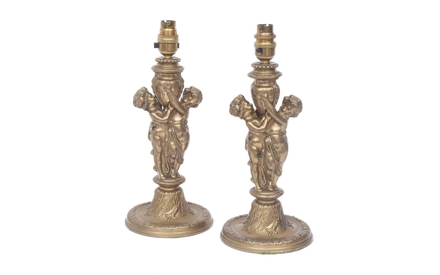 A PAIR OF LOUIS XVI STYLE BRASS LAMPS MODELLED WITH CHERUBS