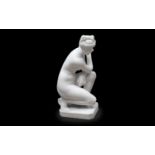 AN EARLY 20TH CENTURY ITALIAN CARVED MARBLE FIGURE OF THE CROUCHING VENUS