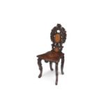 A LATE 19TH CENTURY BLACK FOREST CARVED WOOD HALL CHAIR