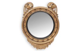 A REGENCY GILTWOOD AND GESSO CONVEX MIRROR