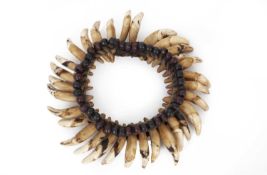 TRIBAL ART / ETHNOGRAPHIC JEWELLERY: A DOG TOOTH BRACELET WITH 31 TEETH