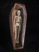 AN EARLY 20TH CENTURY MINIATURE BONE ARTICULATED HUMAN SKELETON