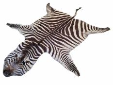 A LARGE ZEBRA (EQUUS QUAGGA) FLAT SKIN RUG