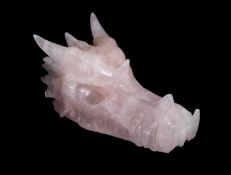 A ROSE QUARTZ CRYSTAL CARVED AS A DRAGON'S HEAD