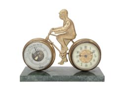 A GILT BRASS DESK COMPENDIUM MODELLED AS A MAN ON A BICYCLE