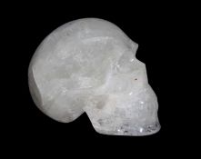 A POLISHED QUARTZ CARVING OF A HUMAN SKULL