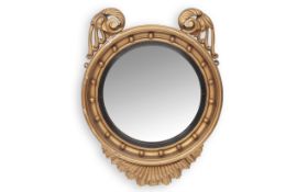 A REGENCY GILTWOOD AND GESSO CONVEX MIRROR