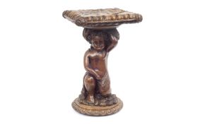 A LATE 19TH CENTURY ITALIAN WALNUT STAND CARVED WITH A PUTTO