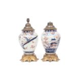 A PAIR OF JAPANESE 17TH CENTURY EDO PERIOD ARITA PORCELAIN AND ORMOLU VASE LAMPS