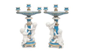 A PAIR OF 19TH CENTURY MINTON PORCELAIN CANDELABRA WITH PUTTI