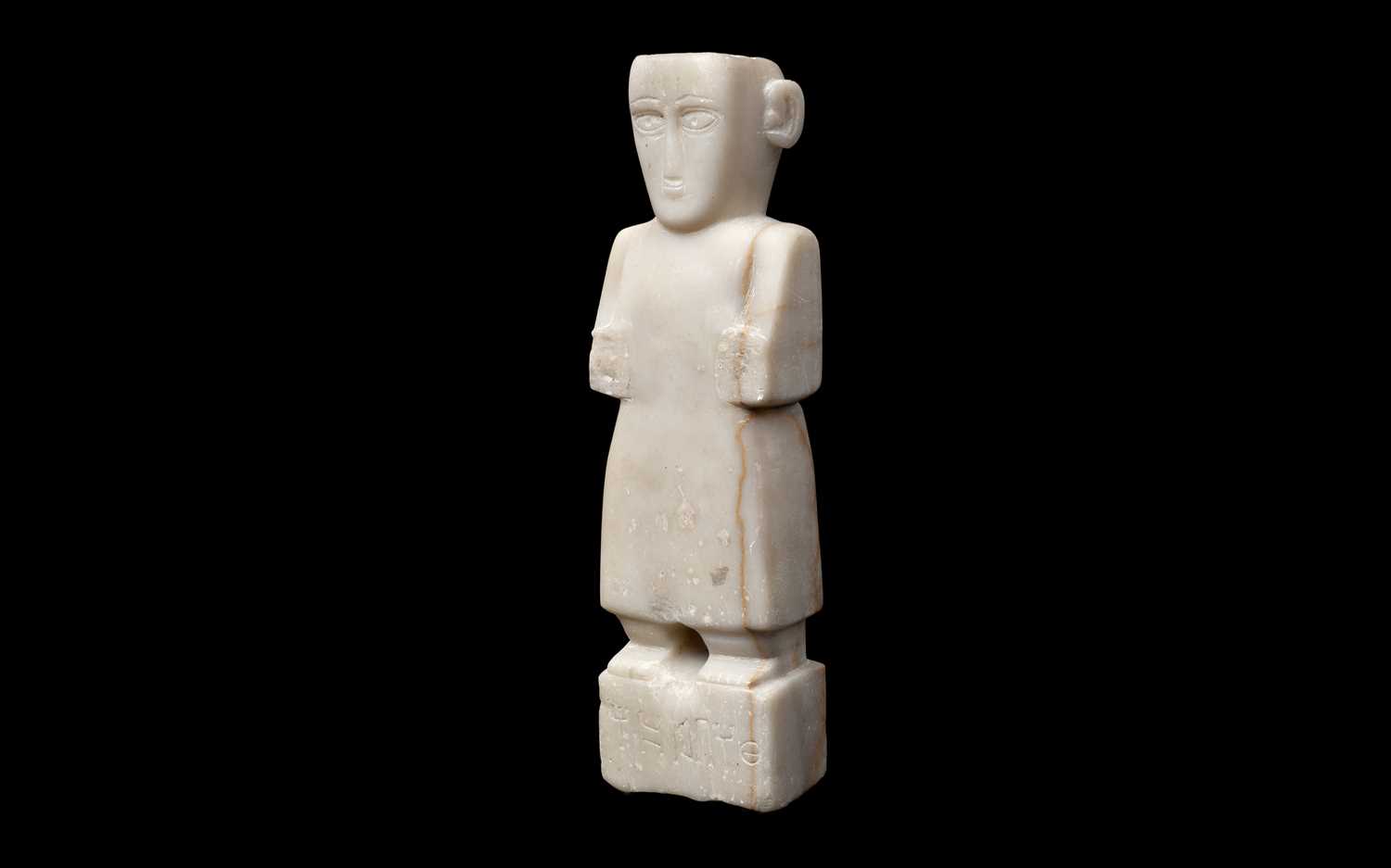 A SOUTH ARABIAN ALABASTER FIGURE OF A STANDING MALE