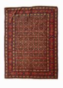 AN EARLY TO MID 20TH CENTURY PERSIAN SENNEH HERATI CARPET