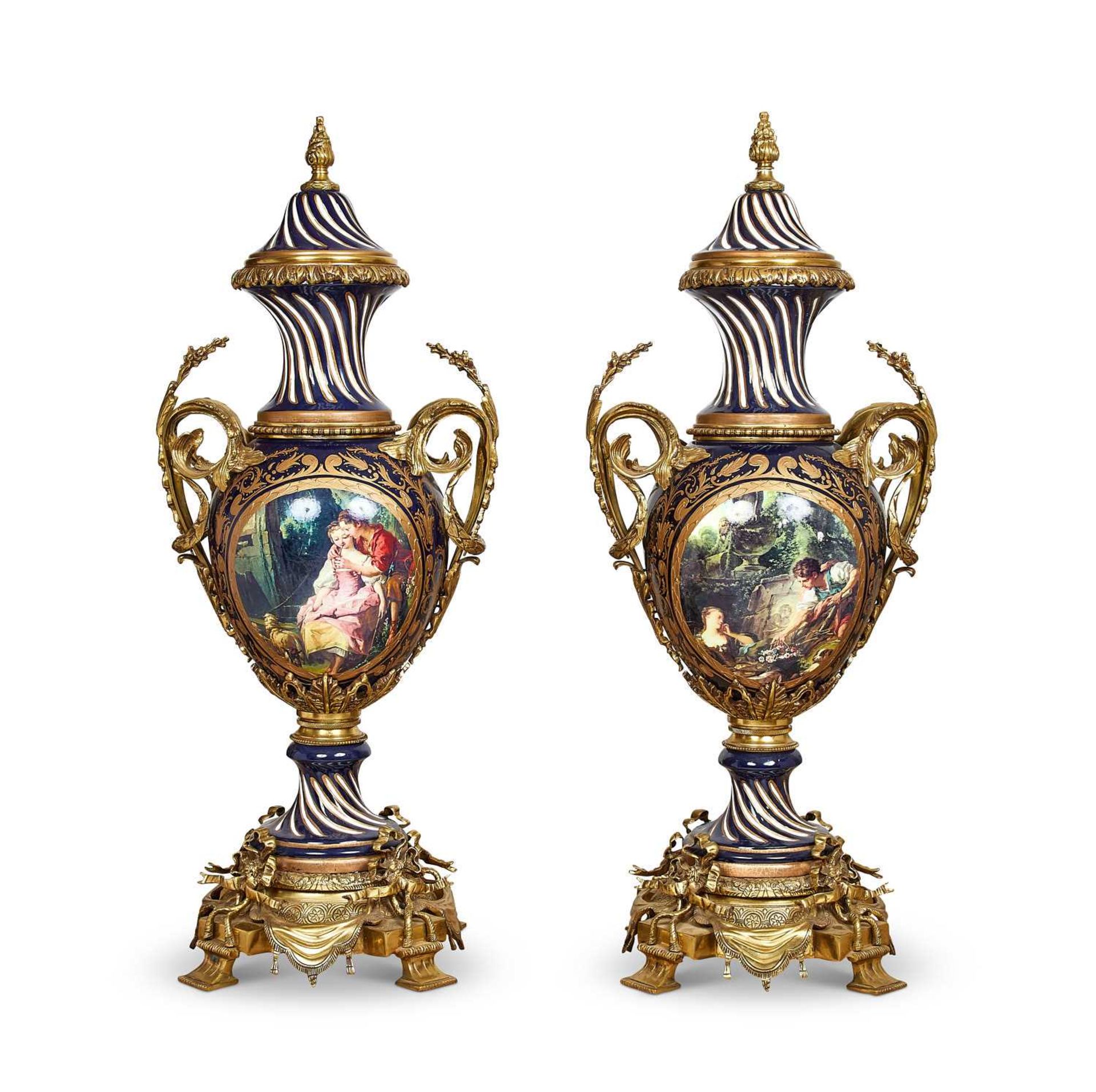 A VERY LARGE PAIR OF LOUIS XVI STYLE PORCELAIN AND GILT BRONZE VASES AND COVERS