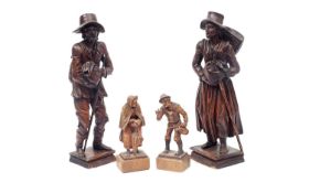 TWO PAIRS OF 19TH CENTURY AUSTRIAN CARVED WOOD FIGURES OF BEGGARS