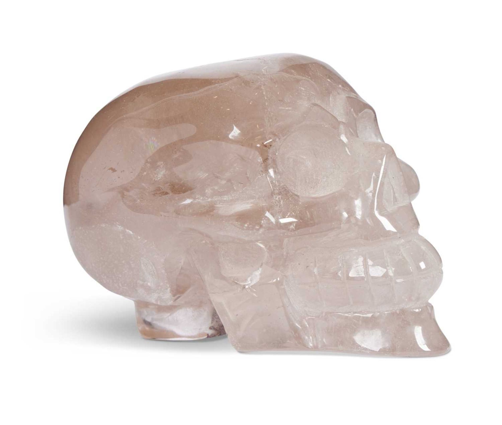 A SOLID CARVED ROCK CRYSTAL MODEL OF A HUMAN SKULL