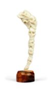 A CARVED ANTLER TINE IN THE FORM OF SEVEN STACKED HUMAN SKULLS