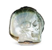 A CARVED BLACK-LIP OYSTER (PINCTADA MARGARITIFERA) MOTHER OF PEARL SHELL WITH SKULL