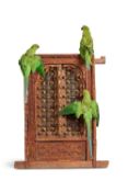 AN ANTIQUE INDIAN WINDOW FEATURING A TRIO OF TAXIDERMY PARAKEETS