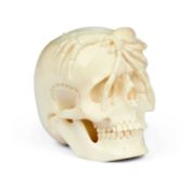 A CARVED BONE MEMENTO MORI IN THE FORM OF A HUMAN SKULL