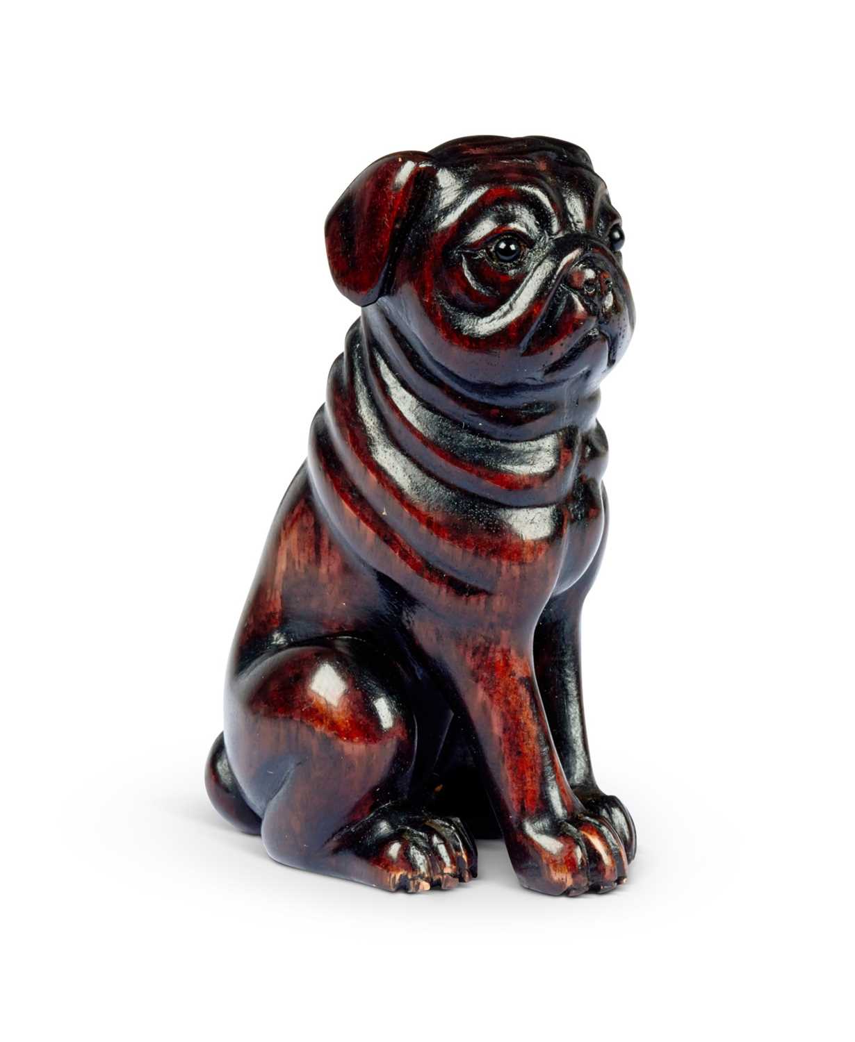 A CARVED HARDWOOD NETSUKE OF A PUG DOG