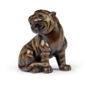 A CARVED HARDWOOD NETSUKE IN THE FORM OF A TIGER