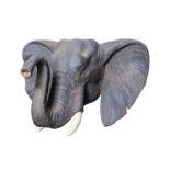 A PAINTED CAST OF A YOUNG ELEPHANT HEAD BY SIMON 'THE STUFFA' WILSON