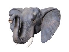 A PAINTED CAST OF A YOUNG ELEPHANT HEAD BY SIMON 'THE STUFFA' WILSON