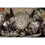 A TRAY OF SILVER PLATED METALWARE TO INCLUDE A THREE PIECE TEA SERVICE, CANDLE STICKS, ETC