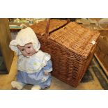 A WICKER HAMPER BASKET CONTAINING VINTAGE EVENING WARE AND A VINTAGE ROLLER EYE DOLL MARKED 037-3