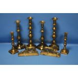 THREE PAIRS OF BRASS CANDLESTICKS AND A PAIR OF BRASS GREYHOUNDS
