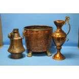 A LARGE COPPER BUCKET WITH LION PAW FEET TOGETHER WITH TWO COPPER JUGS