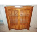 A SERPENTINE FRONTED MAHOGANY CHINA CABINET