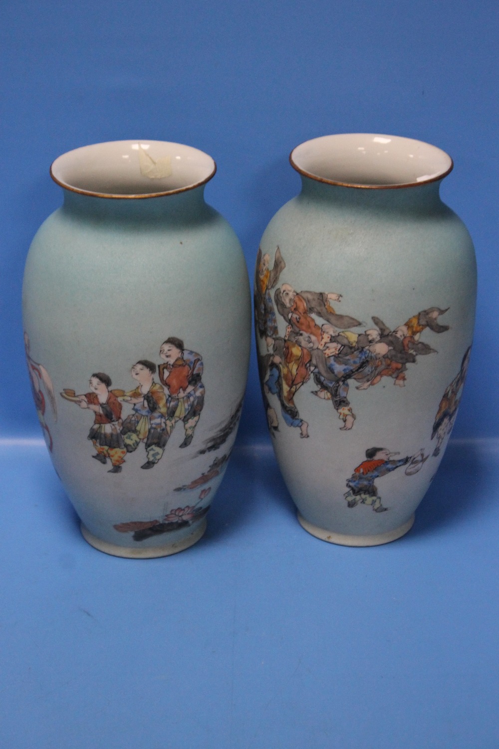 A PAIR OF JAPANESE MEIJI ERA ENAMELLED PORCELAIN VASES BY TAKUCHI CHUBEI, DECORATED WITH FIGURES,